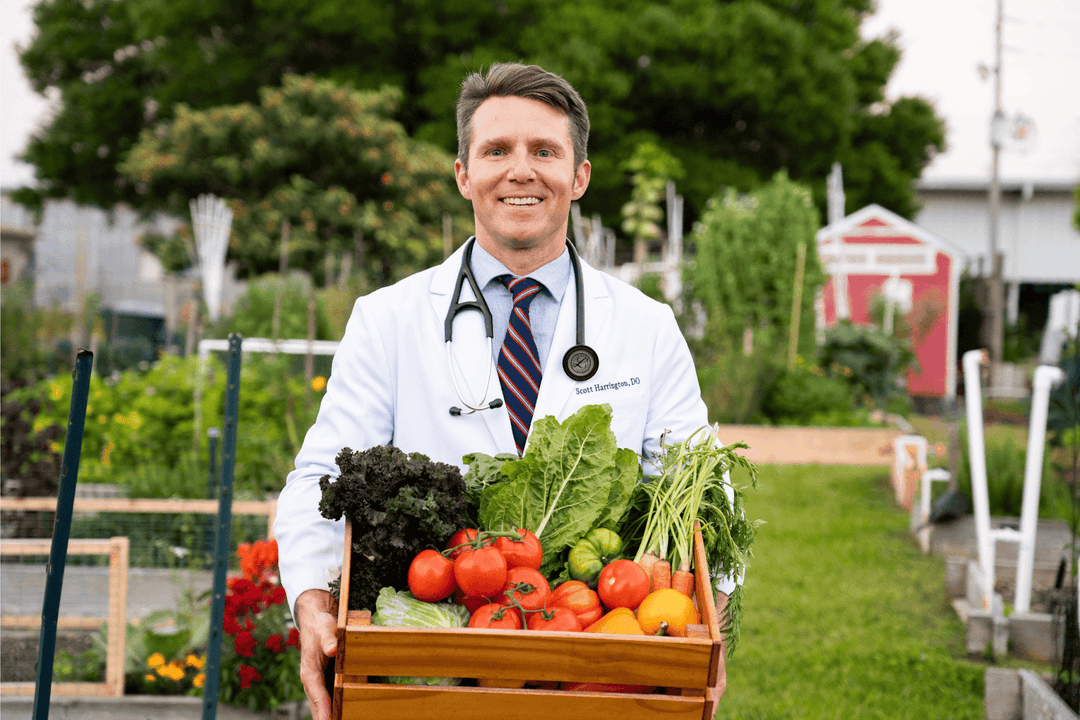 Dr. Scott Harrington holding fresh vegetables